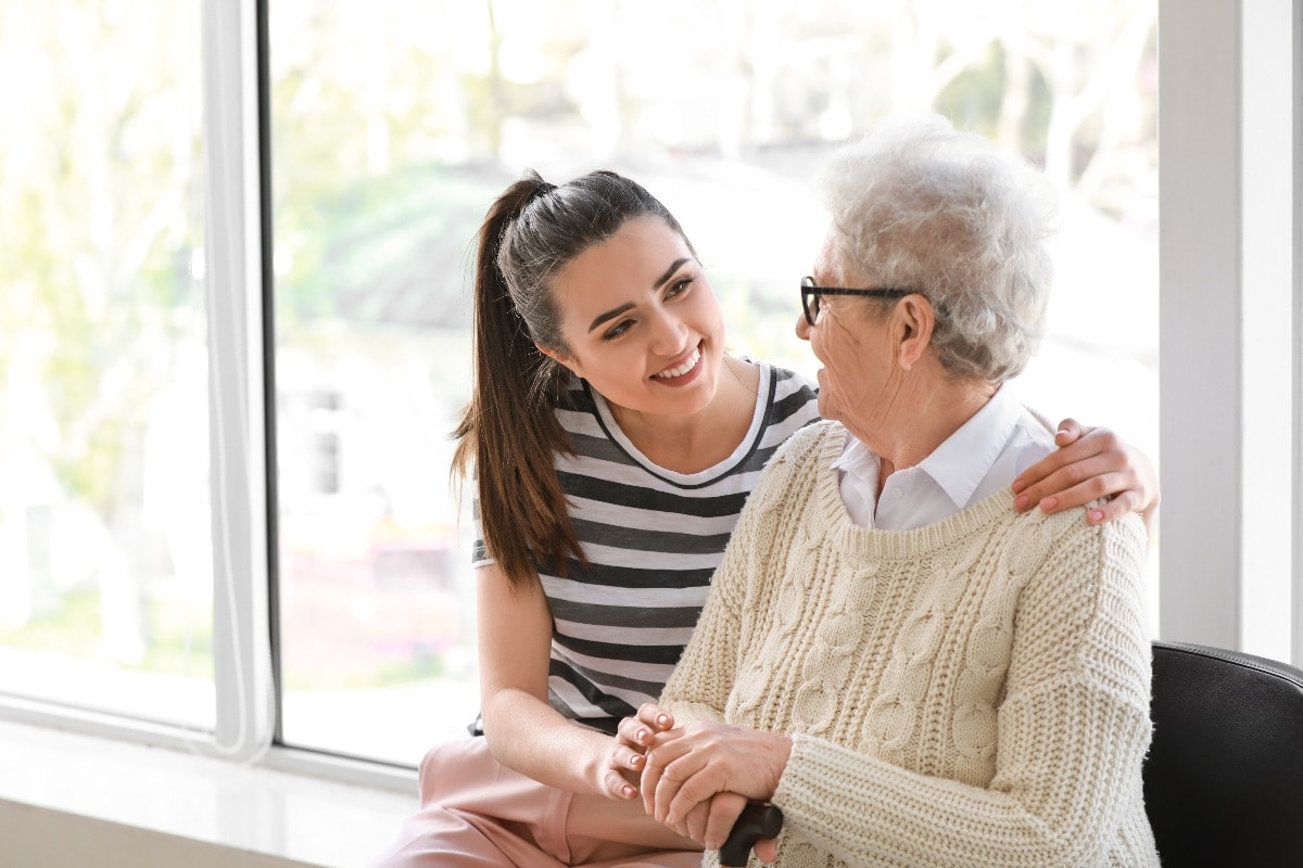 Caregiver with senior woman in nursing home