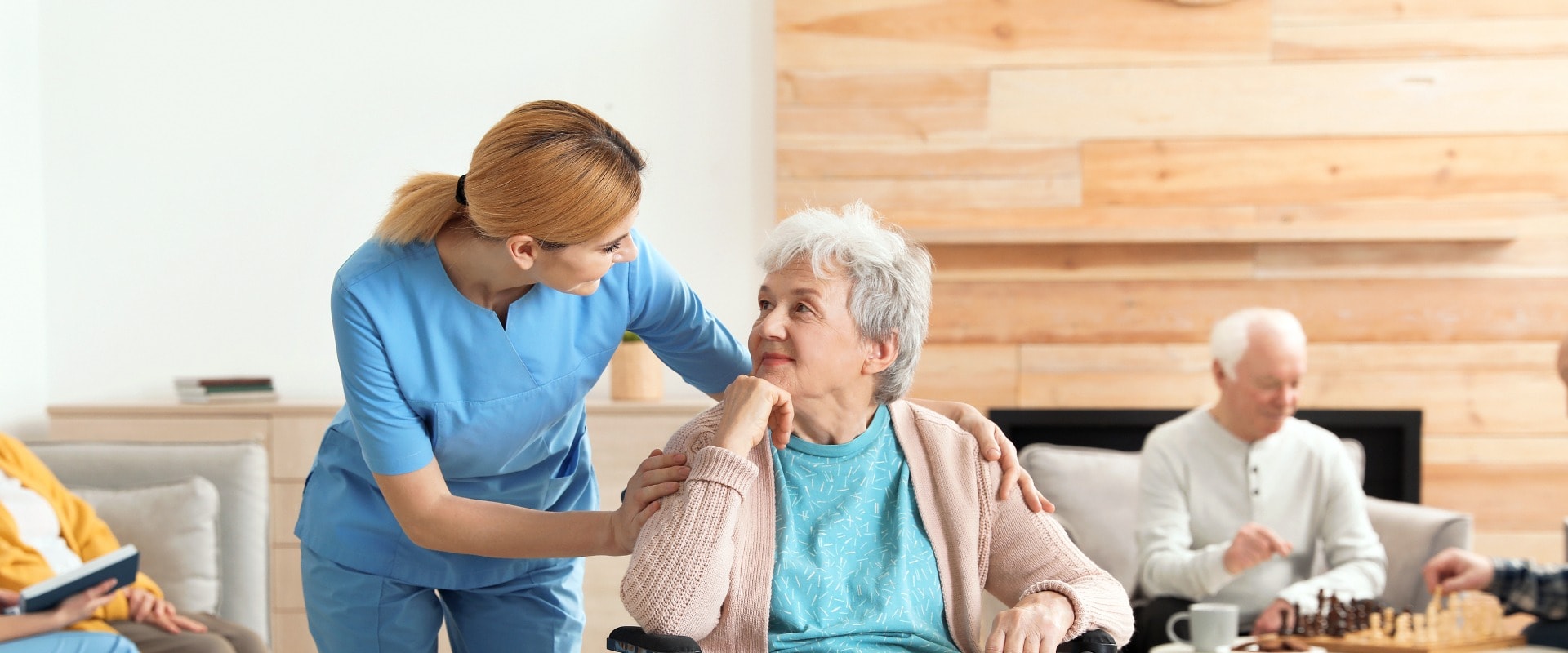 Nurses assisting elderly people at retirement home